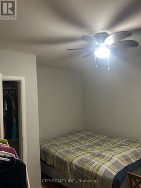 Ajax (Central West) multi-family for rent - A bedroom with a bed and a ceiling fan.