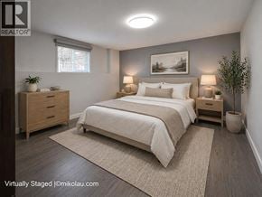 Burnaby apartment for rent - A bedroom with a large bed, two nightstands, and a plant.
