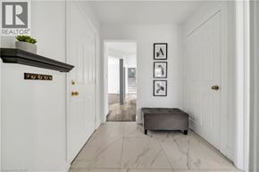 Kitchener apartment for rent - A hallway with a bench and pictures on the wall.
