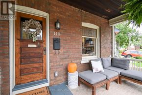 Toronto (The Beaches) apartment for rent - A house number 118 with a door and a sofa on the porch.