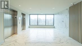 Waterloo condo for rent - A spacious hallway with marble flooring and a glass door leading to a window.