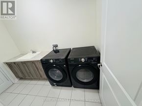 Wellington North (Arthur) apartment for rent - Two black washing machines in a small laundry room.