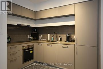 Toronto (Yonge-St. Clair) condo for rent - A modern kitchen with Union Capital Realty Brokerage logo.