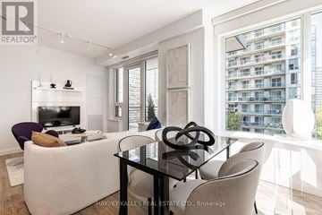 Toronto (Mount Pleasant West) condo for rent - A modern living room with a glass table and a white sofa.