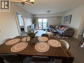 Lasalle condo for rent - A dining room with a wooden table and chairs.