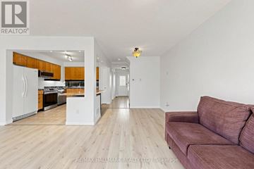 Newmarket (Summerhill Estates) townhouse for rent - A living room with a couch and a kitchen area in the background.