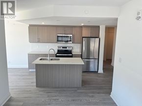 Barrie (Little Lake) condo for rent - A kitchen with a sink, stove, and refrigerator.
