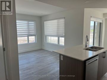 Barrie (Little Lake) condo for rent - A kitchen with a sink and a window with blinds.
