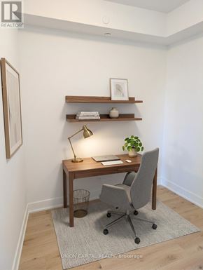 Burlington (Brant) condo for rent - A small desk with a chair and a lamp is in a room.