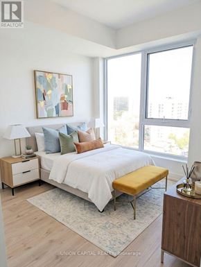 Burlington (Brant) condo for rent - A bedroom with a bed, nightstand, and a painting on the wall.