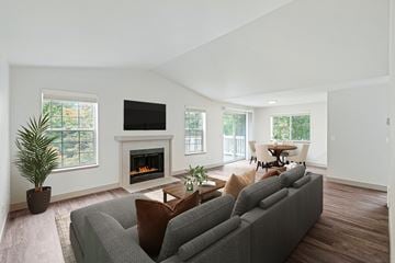 Everett apartment for rent - A living room with a grey couch and a fireplace.