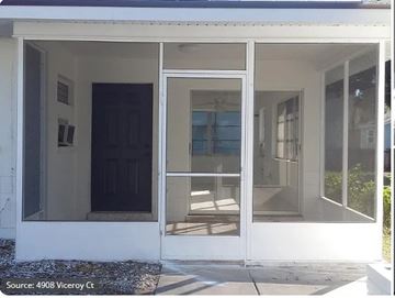 Cape Coral apartment for rent - A white house with a black door and glass windows.
