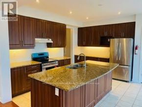 Brampton (Credit Valley) apartment for rent - A kitchen with brown cabinets and granite countertops.