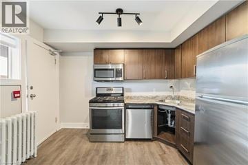 Hamilton apartment for rent - A modern kitchen with wooden cabinets and stainless steel appliances.