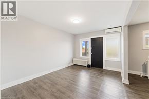 Hamilton apartment for rent - A room with a wooden floor and a black door.