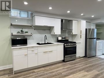 Thorold (Rolling Meadows) apartment for rent - A modern kitchen with white cabinets and stainless steel appliances.