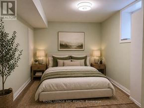 Thorold (Rolling Meadows) apartment for rent - A bedroom with a bed, nightstands, and a plant.