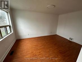 Toronto (Clairlea-Birchmount) apartment for rent - A room with wooden flooring and white walls.