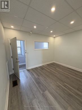Guelph (Downtown) multi-family for rent - A white toilet in a small bathroom with a walk-in shower.