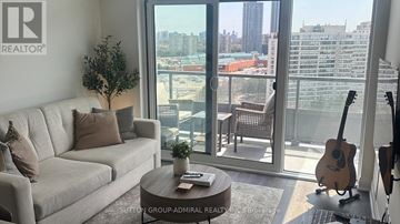 Vaughan (Beverley Glen) condo for rent - A living room with a couch, a coffee table, and a guitar.