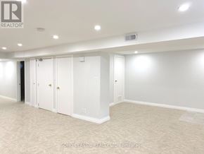 Newmarket (Huron Heights-Leslie Valley) apartment for rent - A room with white walls and carpeted floor with a brokerage sign.