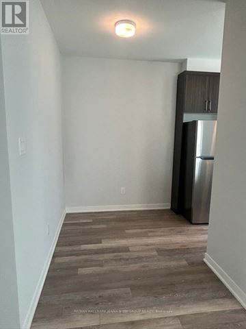 Ottawa townhouse for rent - A kitchen area with a refrigerator and wooden flooring.