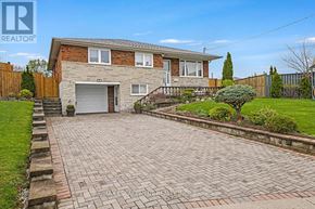 Toronto (Rustic) apartment for rent - A house with a brick driveway and a garage door.