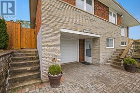 Toronto (Rustic) apartment for rent - A brick house with a white door and a small garden in front.