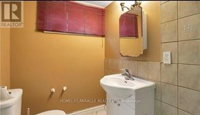 Hamilton (Eleanor) apartment for rent - A bathroom with a toilet, sink, and window.