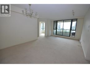 Richmond apartment for rent - A large, empty room with a chandelier and a window with black bars.