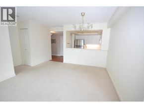 Richmond apartment for rent - A large empty room with a chandelier and a window seat.