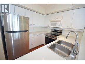 Richmond apartment for rent - A kitchen with white cabinets and a stainless steel refrigerator.
