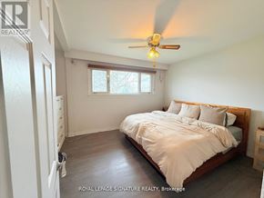 Oakville (Go Glenorchy) apartment for rent - A bedroom with a bed, dresser, and window.