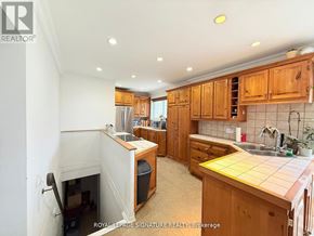 Oakville (Go Glenorchy) apartment for rent - A kitchen with wooden cabinets and a white countertop.