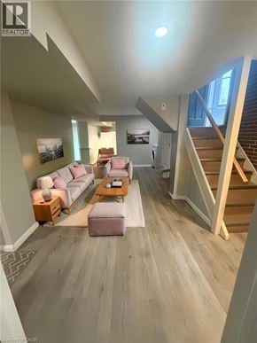 Hamilton apartment for rent - A living room with a couch, a coffee table, and a staircase.