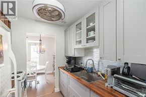Hamilton apartment for rent - A well-lit kitchen with white cabinets and a wooden countertop.