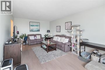 Hamilton apartment for rent - A living room with a grey couch and a wooden coffee table.