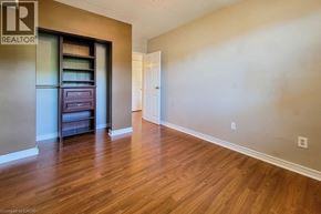 Hamilton condo for rent - A room with wood flooring and a built-in cabinet.