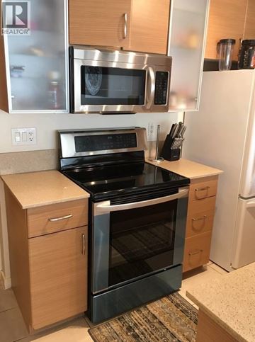 Vancouver apartment for rent - A kitchen with a stove top oven and microwave.