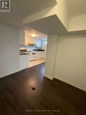 Richmond Hill (Crosby) apartment for rent - A kitchen with white cabinets and a black countertop.