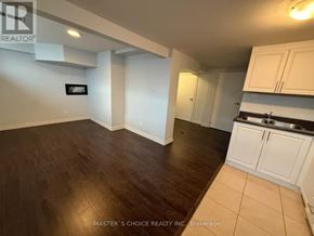 Richmond Hill (Crosby) apartment for rent - A kitchen area with white cabinets and a wooden floor.