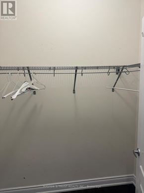 Vaughan (Patterson) apartment for rent - A white closet with clothes hangers.