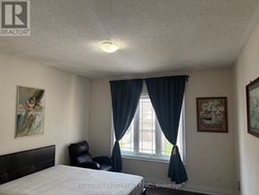 Vaughan (Patterson) apartment for rent - A bedroom with a bed, chair, and two pictures on the wall.