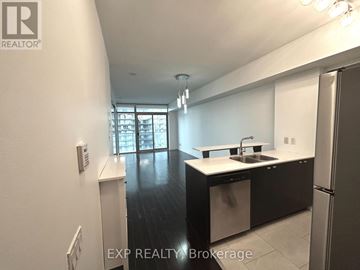 Toronto (High Park-Swansea) condo for rent - A kitchen with white cabinets and a black countertop.
