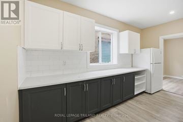 London East (East K) apartment for rent - A kitchen with white cabinets and a black counter.