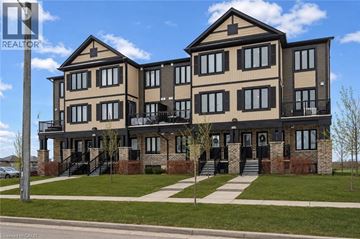 Kitchener condo for rent - A large two story house with a balcony on the second floor.