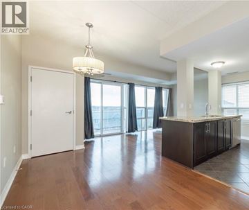 Milton condo for rent - A well-lit, spacious kitchen and living room with hardwood floors and a large window.