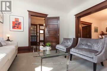 Toronto (South Parkdale) apartment for rent - A living room with a glass coffee table and two grey couches.