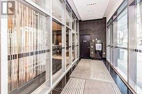 Toronto (Waterfront Communities) condo for rent - A hallway with a glass wall and a black door.