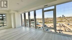 Toronto (Banbury-Don Mills) condo for rent - A realtor company is showcasing a spacious room with a view of the city.